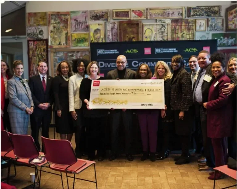 MIEC leaders holding a large cheque at the AGAP launch event