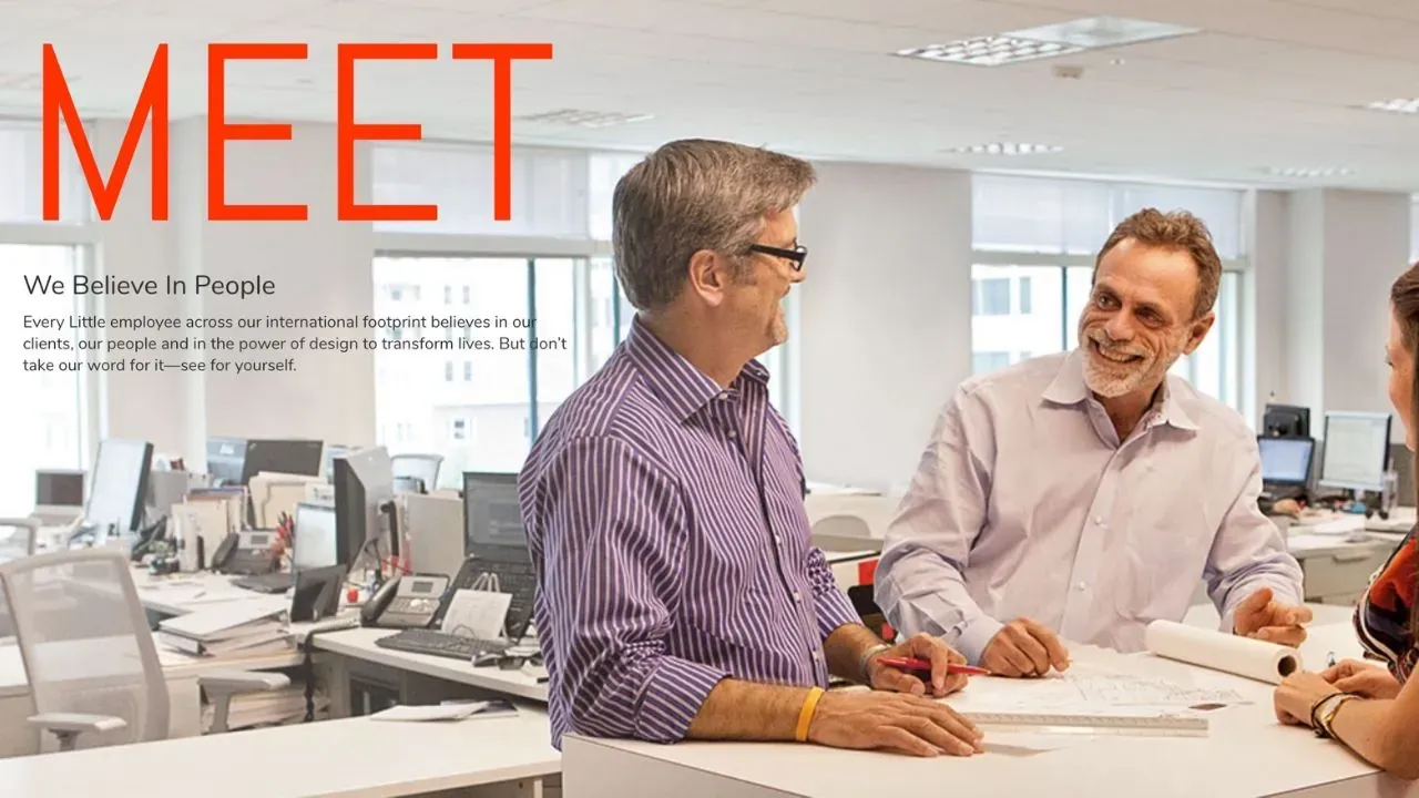 Two colleagues talking over drawings in an architecture office